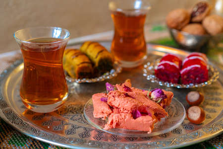 Turkish sweet baklava on metal tray with Turkish teaの写真素材
