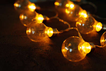 Garland of light bulb lamps in the darkの写真素材