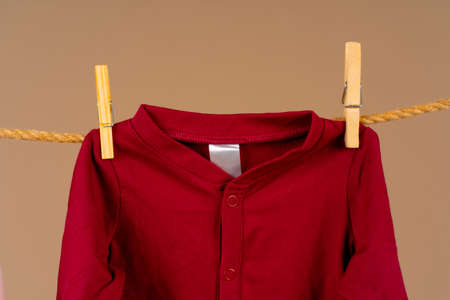 Kids apparel pinned to a clothesline to dryの写真素材