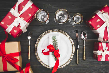 Black wooden table with stylish Christmas table settingの写真素材