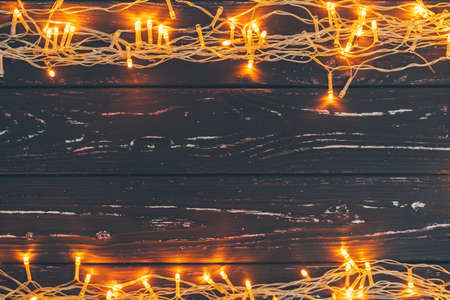 Christmas garland on wooden background with copy spaceの写真素材