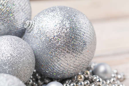 Shiny silver glitter baubles close up on wooden tableの写真素材