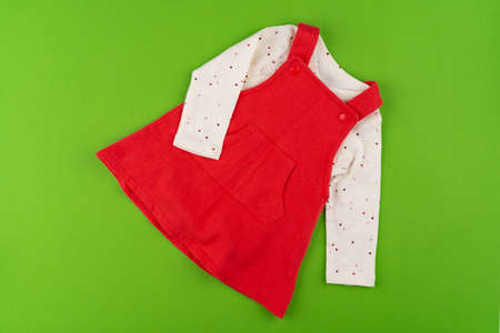 Top view of baby clothes on green backgroundの写真素材