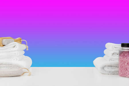 Bath towels and spa salt on white tableの写真素材
