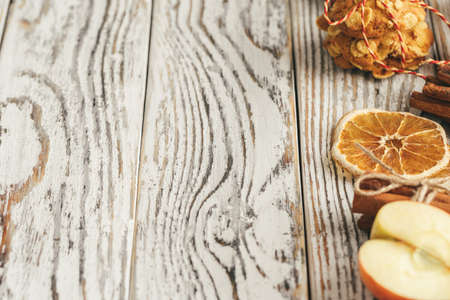 Oatmeal cookies on a old wooden background with cinnamon sticks and decorationsの写真素材