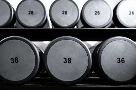 Rows of metal dumbbells on rack for bodybuilding in gymの写真素材