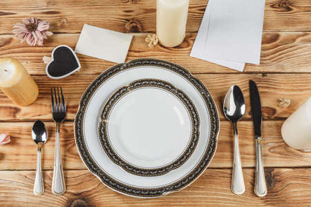 Beautiful table setting on wooden table from above