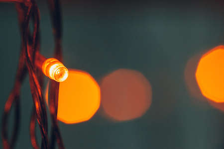 Illuminated garland close up on dark background