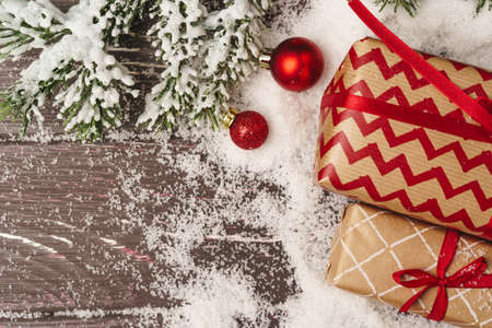 Christmas gift on wooden table powdered with snow