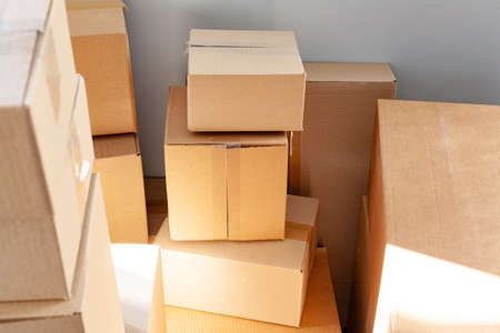 House moving concept with stacked cardboard boxes in a room