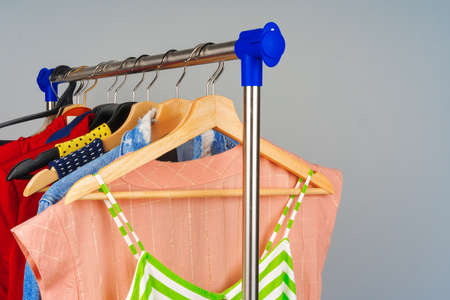 Woman colorful different clothes on hanger close up