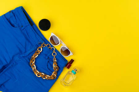 Trendy woman outfit with accessories on bright yellow backgroundの写真素材