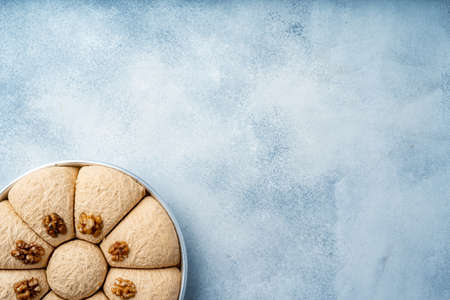 Top view of Turkish desserts on light blue background