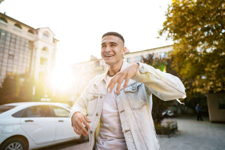 Portrait of handsome young casual man walking on the street