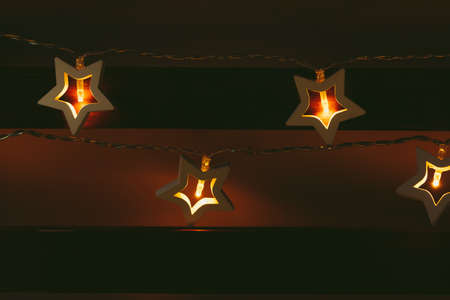 Beautiful bokeh light of star shaped garland in the dark