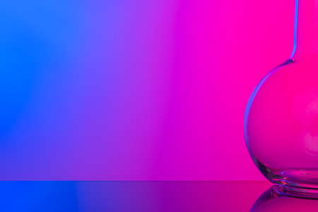 Chemical glassware close up on neon pink-purple backgroundの写真素材
