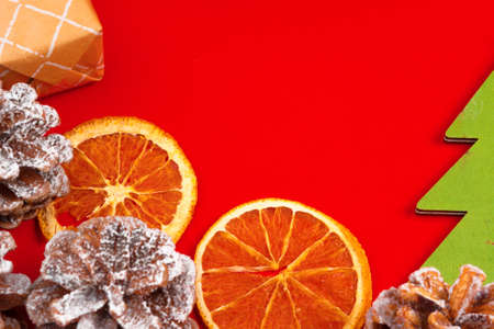 Christmas composition on red background with pine conesの写真素材