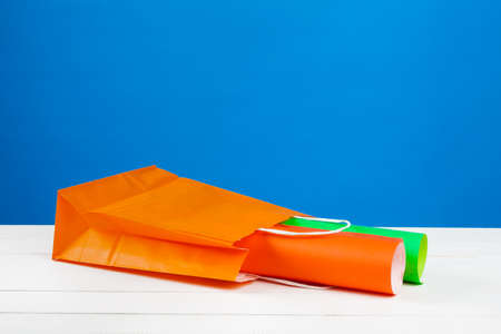 Paper shopping bags with copy space on blue background
