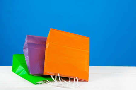 Paper shopping bags with copy space on blue backgroundの写真素材