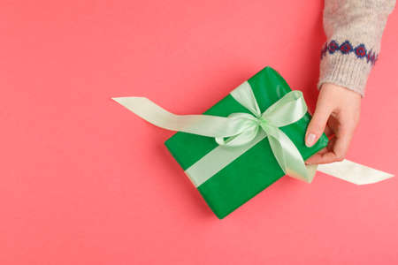 Small gift box in female hands, view from aboveの写真素材