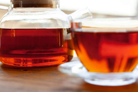 Hot cup of tea on wooden rustic table close up