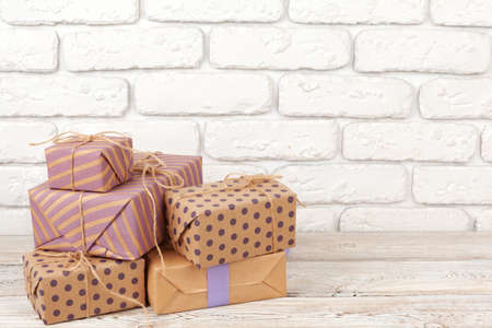 Colorful gift boxes against white brick wall background