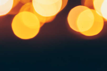 Abstract Gold bokeh sparkle on dark backgroundの写真素材