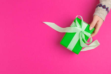 Small gift box in female hands, view from aboveの写真素材