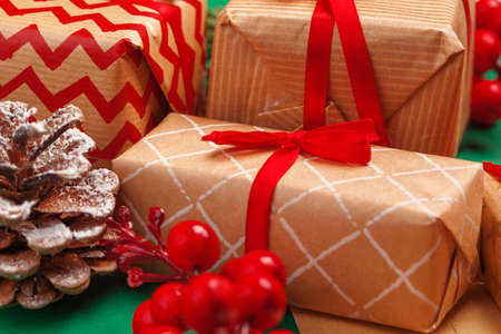 Craft christmas gifts with red ribbons on decorated christmas background