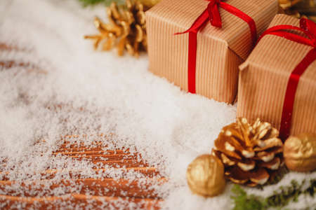 Decorated present on snowy wooden table close upの写真素材