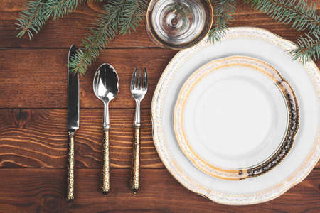 Christmas table setting with pine tree branches and decorations top viewの写真素材