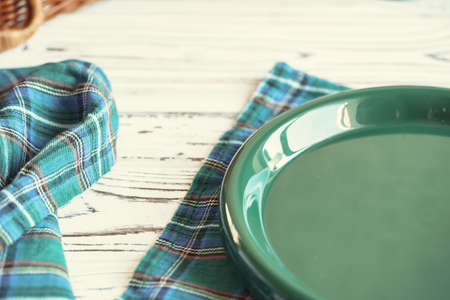 Green plastic kitchenware on a table close up
