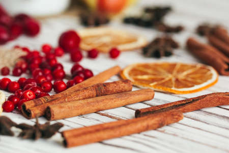 Berries and spices for mulled wine cooking close up on kitchen table