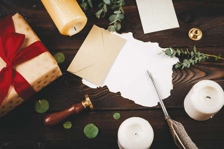 Writing Christmas post on holiday wooden decorated backgroundの写真素材