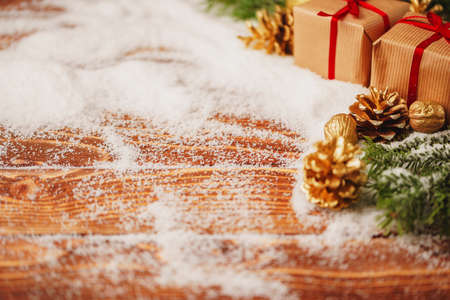 Decorated present on snowy wooden table close upの写真素材