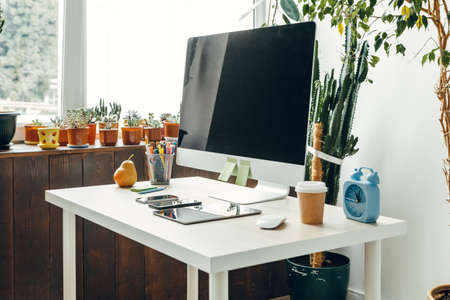 Office or home workspace. Computer monitor with black screen on office table with supplies