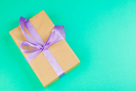 Decorated gift box on a green background, flat lay top view