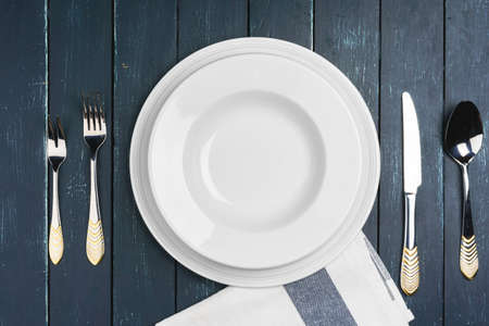 Table setup with plates on dark wooden background
