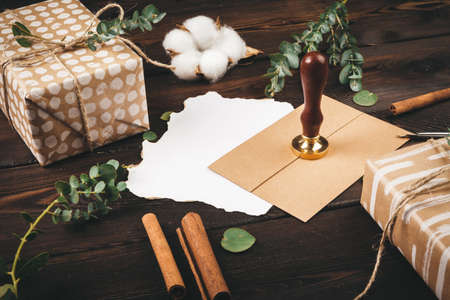 Writing holiday vintage style greeting card on wooden table, copy space