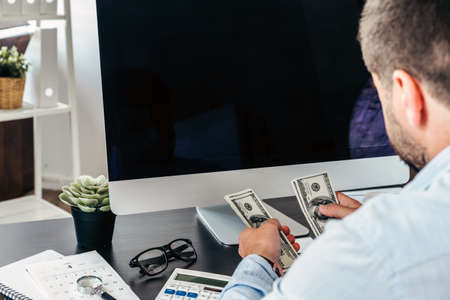 Close up of a businessman at his working table in officeの写真素材