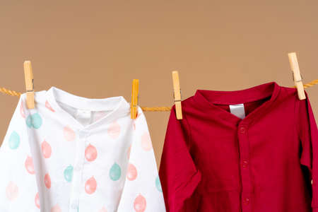 Kids apparel pinned to a clothesline to dryの写真素材