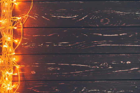 Christmas garland on wooden background with copy spaceの写真素材