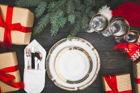 Black wooden table with stylish Christmas table settingの写真素材