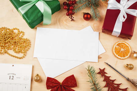 Greeting letter, envelope and feather surrounded by Christmas decorationsの写真素材