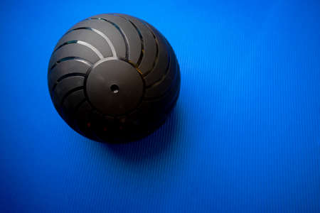 Black fitness ball on blue mat backgorundの写真素材