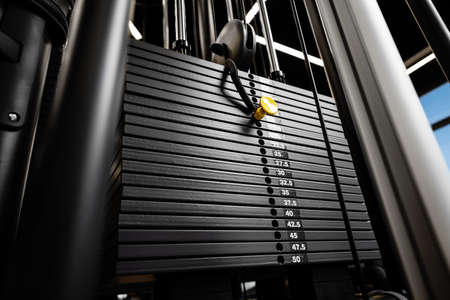 Stacked iron plates of weight machine in gym