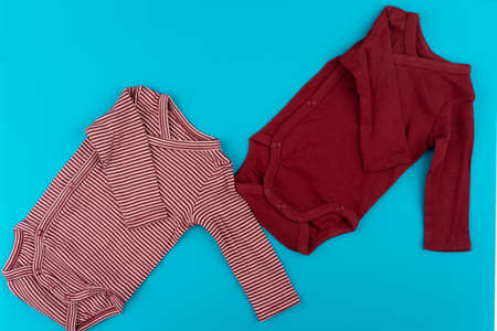 baby clothes on blue background top viewの写真素材