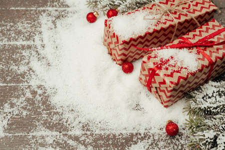Snowy composition with Christmas gift on wooden tableの写真素材