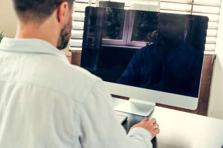 Young man businessman sitting at his working table in officeの写真素材