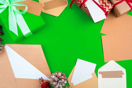 Desk with envelope and Christmas decorations. Flat lay. Mockup